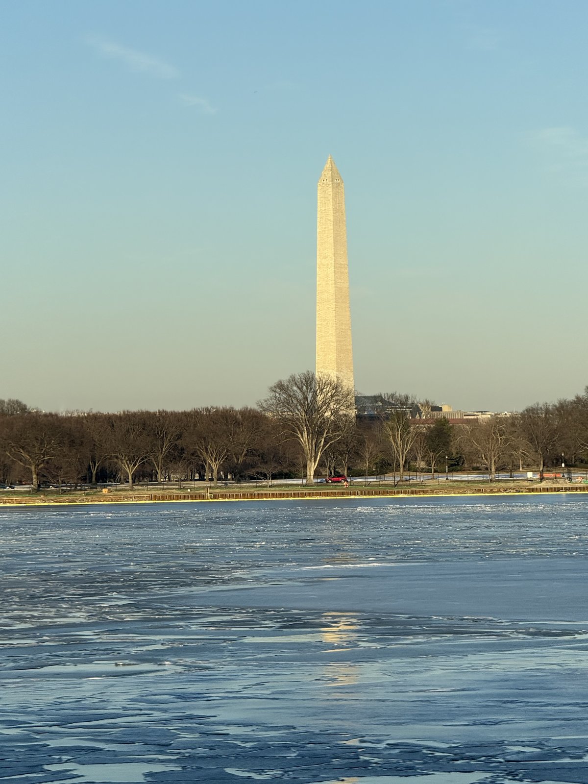 The Washington Monument seen across the frozen Tidal Basin on a clear winter afternoon